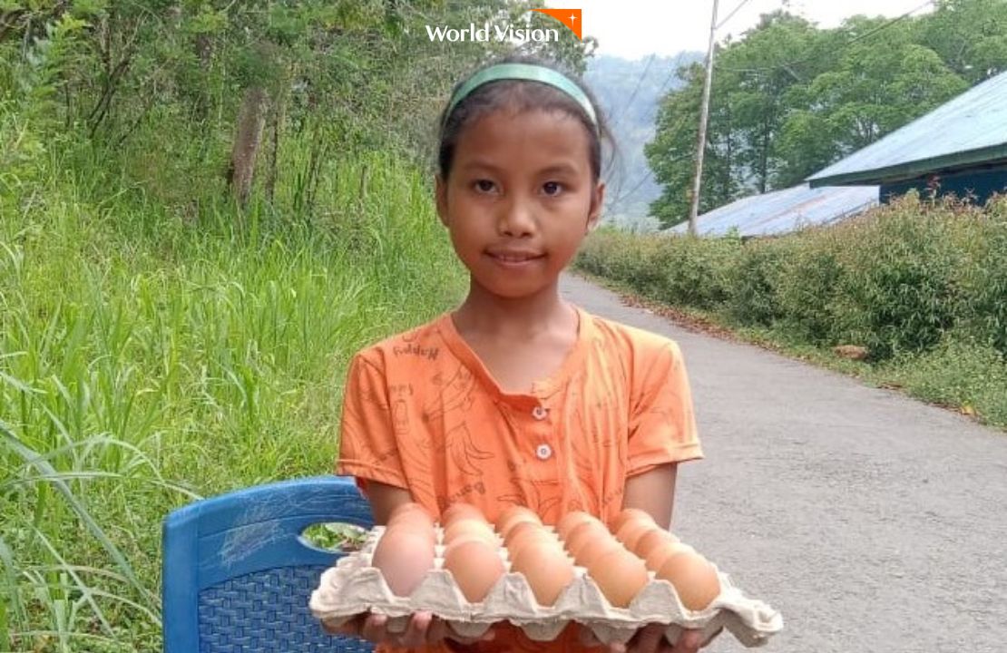 계란 한판을 들고 미소짓고 있는 여자아이